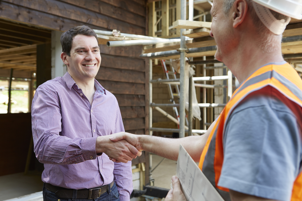 Customer Shaking Hands With Builder